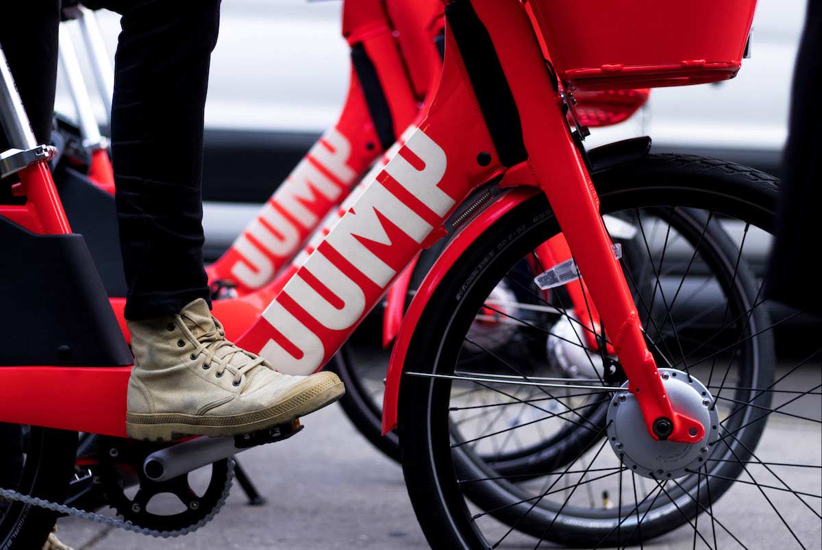 Image features red Jump bikes.