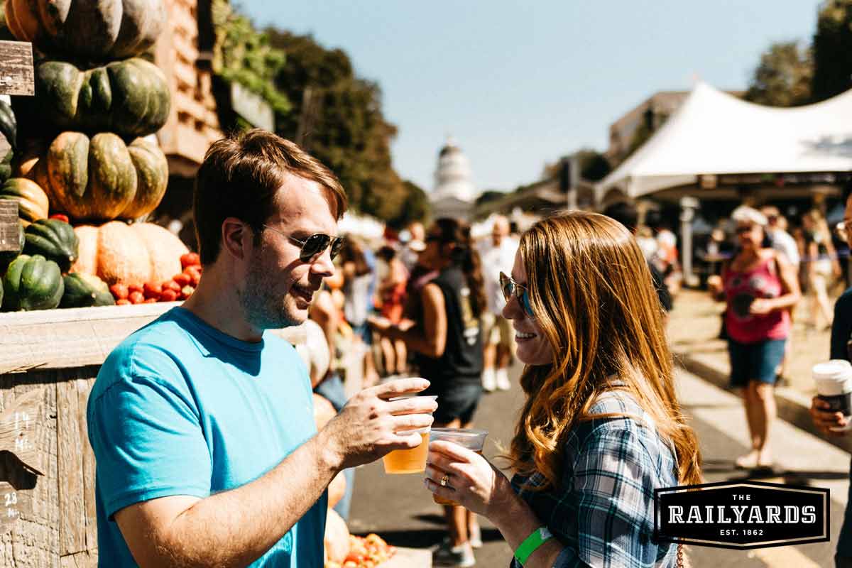 A couple sharing drinks at Sacramento's Farm to Fork Festival.