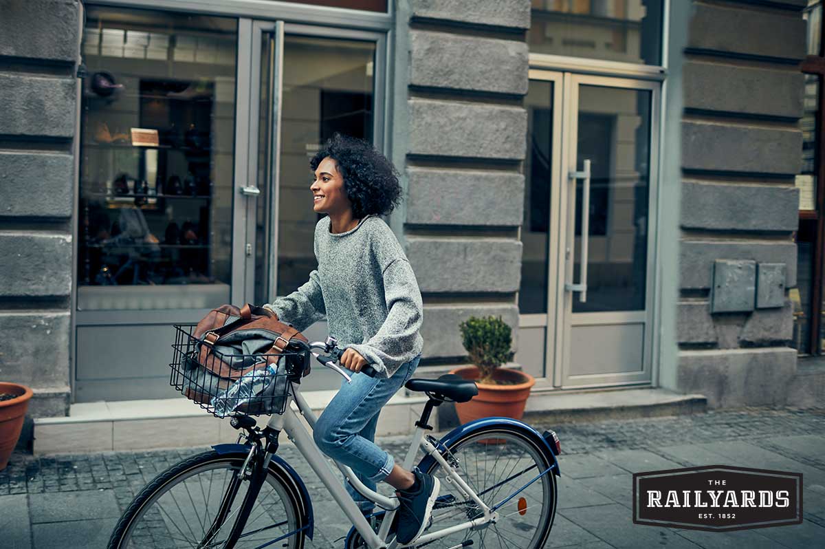 A woman bikes to work through city streets.