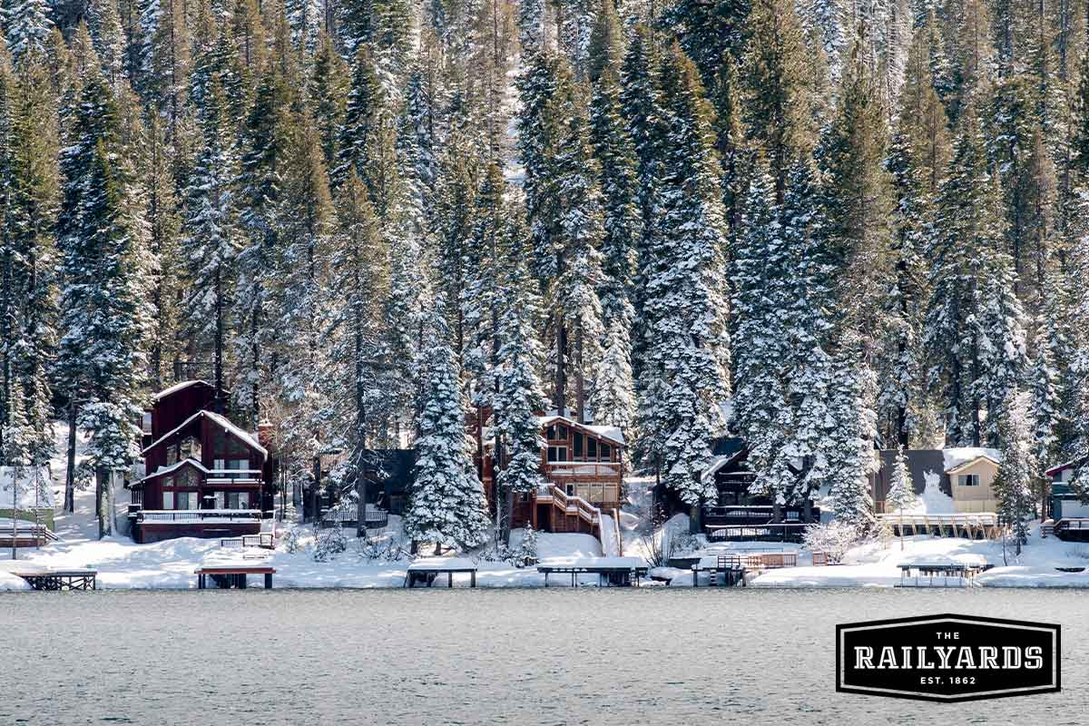 Three Lake Tahoe cabins covered in winter snow.