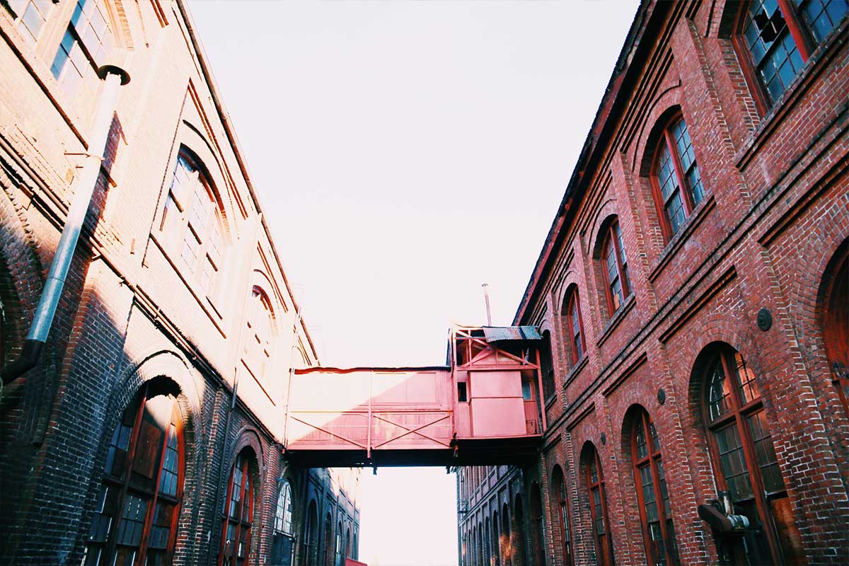 An exterior image of historic brick buildings in the Sacramento Railyards before renovation or repair.